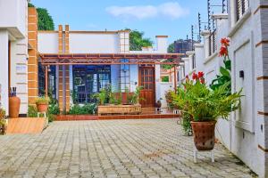 a house with a courtyard with plants and flowers at Lavish Luxury Homes in Tengeru