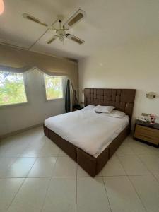 a bedroom with a bed and a ceiling fan at Sea View Apartment with Full kitchen and living room in Sharm El Sheikh