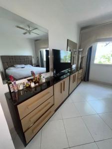 a bedroom with a bed and a television on a dresser at Sea View Apartment with Full kitchen and living room in Sharm El Sheikh +19 photos