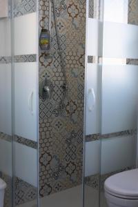 a bathroom with a shower with a toilet at La Terrazza di Porticello in Porticello