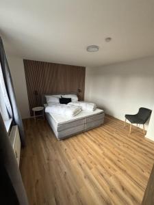 a bedroom with a bed and a wooden floor at Rathauswiese Ferienwohnung in Braunlage