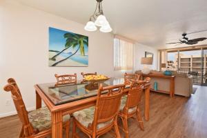 a dining room with a glass table and chairs at Royal Kahana 1020 · RK 1020 BeachFront 2BD Condo w Ocean Views A in Kahana