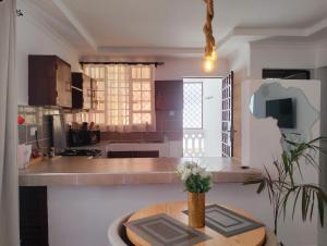 a kitchen with a wooden table in a room at Erwin Holiday Homes in Diani Beach