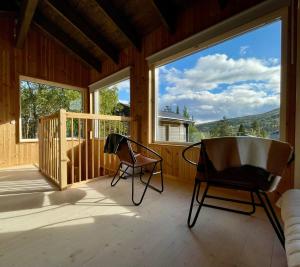 a porch with a rocking chair and large windows at House on Dundret in Gällivare