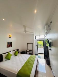 Ένα ή περισσότερα κρεβάτια σε δωμάτιο στο Jaffna City Palace Hotel