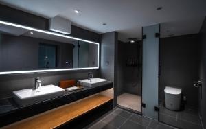 a bathroom with two sinks and a mirror at Liu Ruju Song's Courtyard in Lijiang
