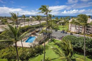 an aerial view of a resort with a pool and palm trees at Kihei Akahi C302 · AKH C302 Spacious 2BD Condo w Ocean Breeze AC in Wailea