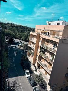 an apartment building with cars parked in a parking lot at Stura Home in Rome