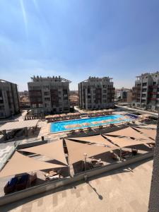 a swimming pool with umbrellas and chairs and buildings at Jw Marriott residence in Cairo