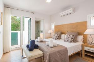 a bedroom with a large bed and a window at Villa del Mar by Menorca Vacations in Son Bou +16 photos