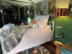 a bedroom with a bed with a pink comforter at Eden's Studio in Sellicks Beach