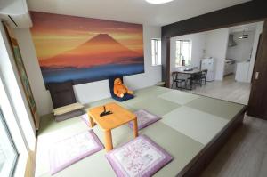 a living room with a painting on the wall at Tokyo Ikebukuro Takahashi Minsyuku in Tokyo