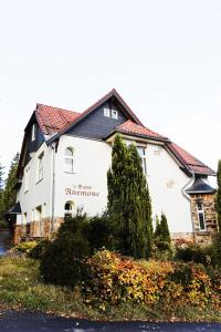 a white building with a sign on the side of it at Ferienapartments in Schierke am Brocken direkte Wanderweglage in Wernigerode
