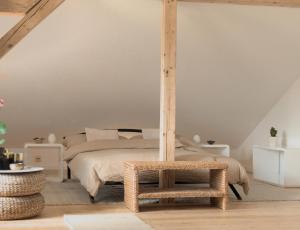 a bedroom with a bed with a stool next to it at Apartment - Sleeps 3 - Balcony - Garden in Feldkirch