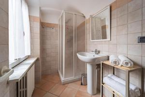 a bathroom with a sink and a shower at La Terrazza in Centro Storico - Free Wifi & AC in Savigliano +11 photos