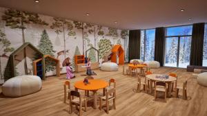 a childrens play room with tables and chairs at Résidence Odalys L'Ecrin Blanc in Montvalezan