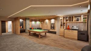 a living room with a pool table in it at Résidence Odalys L'Ecrin Blanc in Montvalezan