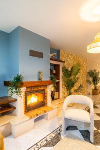 un soggiorno con camino e sedia di Villa Familiar l Piscina I Cine l Bbq l Sala de Juegos I 6min Segovia I 50min Madrid I 17 px a Valseca