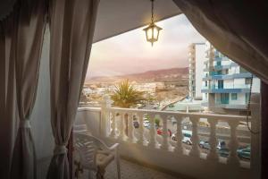 a balcony with a view of a city at Playa Paraiso Seaview in Adeje