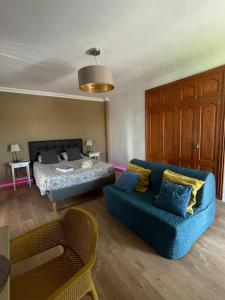 a living room with a bed and a blue couch at Playa Paraiso Seaview in Adeje