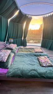 a bedroom with two beds in a tent at Glasigloo in Rozvadov
