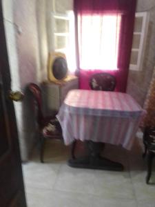 a room with a table and a chair and a window at ادفو35 كامب شيزار دور ثالث in Alexandria
