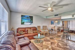 a living room with a leather couch and a table at Sunset Chateau 506 - Premier in St. Pete Beach