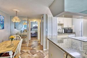 a kitchen with a table and a dining room at Sunset Chateau 506 - Premier in St. Pete Beach