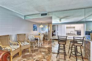 a living room with a table and chairs and a kitchen at Sunset Chateau 506 - Premier in St. Pete Beach