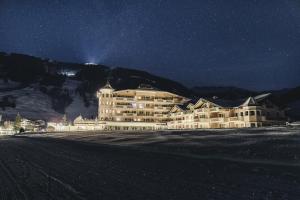 a large hotel at night in the mountains at Traumhotel Alpina Superior in Gerlos