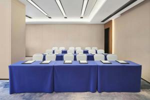 a conference room with a blue table and white chairs at Fairfield by Marriott Guangzhou Huadu in Huadu