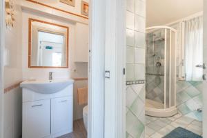a bathroom with a sink and a shower at Seb beach in Costa Rei +23 photos