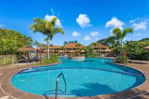 a swimming pool at a resort with palm trees at Maui Kaanapali Villas 415 · MKV 415 Updated Condo w Ocean View a in Kahana