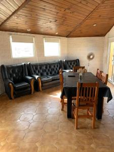 een woonkamer met een zwarte bank en een tafel bij Complejo Gerar in Las Toninas