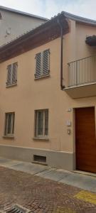 a building with a door and windows on it at CA' 'D Ricardo in Alba