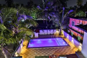 an overhead view of a swimming pool at night at Antonio's hotel in Calangute