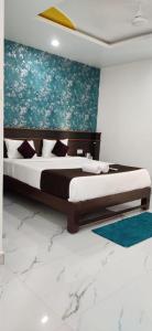 a bedroom with two beds and a painting on the wall at Antonio's hotel in Calangute