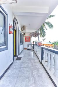 a corridor of a building with a tile floor at Antonio's hotel in Calangute