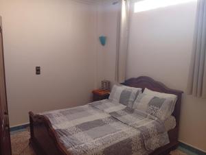 a bedroom with a bed and a window at شقة للكراء اليومي in Aourir