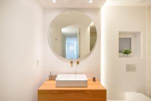 a bathroom with a white sink and a mirror at GuestReady - Condessa Flores Apartments in Lisbon