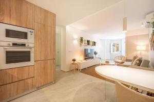 a kitchen and living room with a white counter top at GuestReady - Condessa Flores Apartments in Lisbon