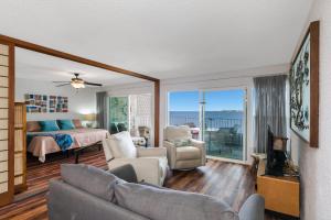 a bedroom and living room with a bed and a couch at Alii Villas #230 condo in Kailua-Kona