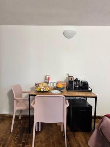 a table with two chairs and a plate of food on it at B&B Nonna Cristina in Nardodipace +5 photos