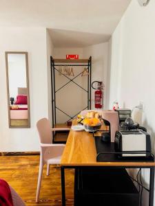 a kitchen with a wooden table and a mirror at B&B Nonna Cristina in Nardodipace