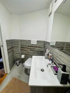 a bathroom with a white sink and a toilet at B&B Nonna Cristina in Nardodipace