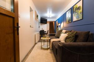a living room with a couch and a table at Central 2-Bedroom House with Shared Courtyard near Old Town Bucharest in Bucharest