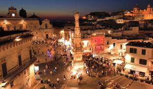 a crowd of people walking around a city at night at Luxury TrullidiGiulia, piscina uso esclusivo in Ostuni