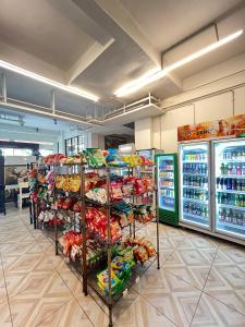 a store aisle with shelves of food and drinks at Anders Arjuna Selatan in Jakarta