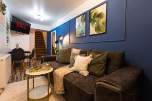 a living room with a brown couch and a table at Central 2-Bedroom House with Shared Courtyard near Old Town Bucharest in Bucharest +32 photos