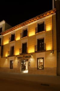a building with lights on the side of it at Posada del León de Oro Boutique Hotel in Madrid